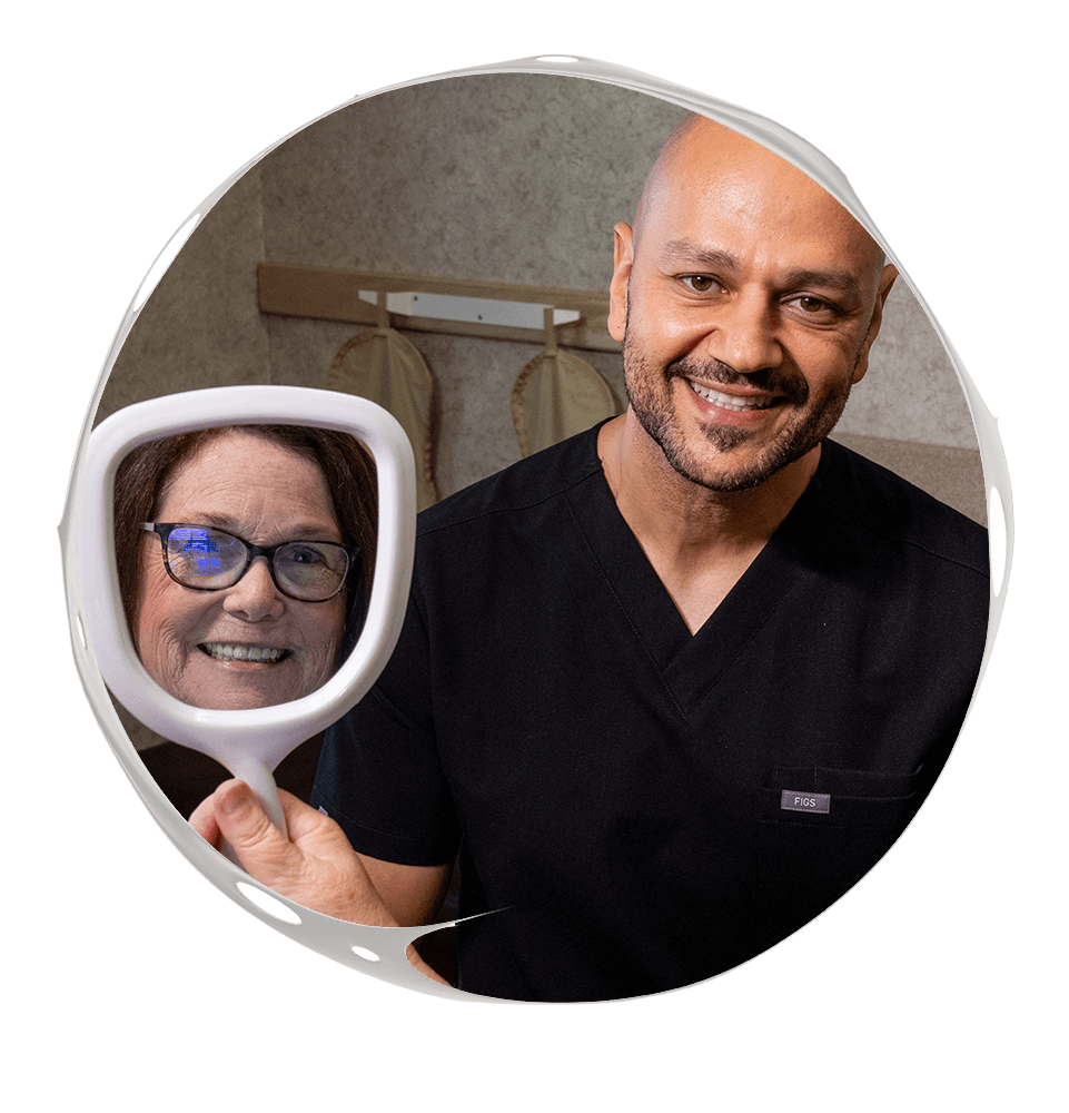 Patient looking into mirror with doctor