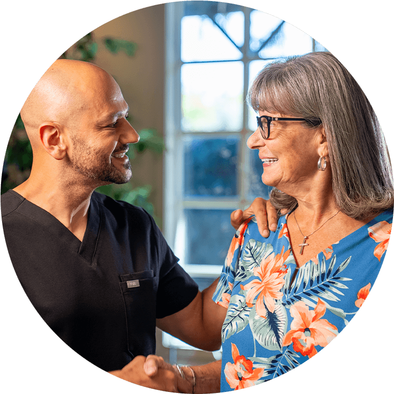 doctor smiling at patient shaking her hand