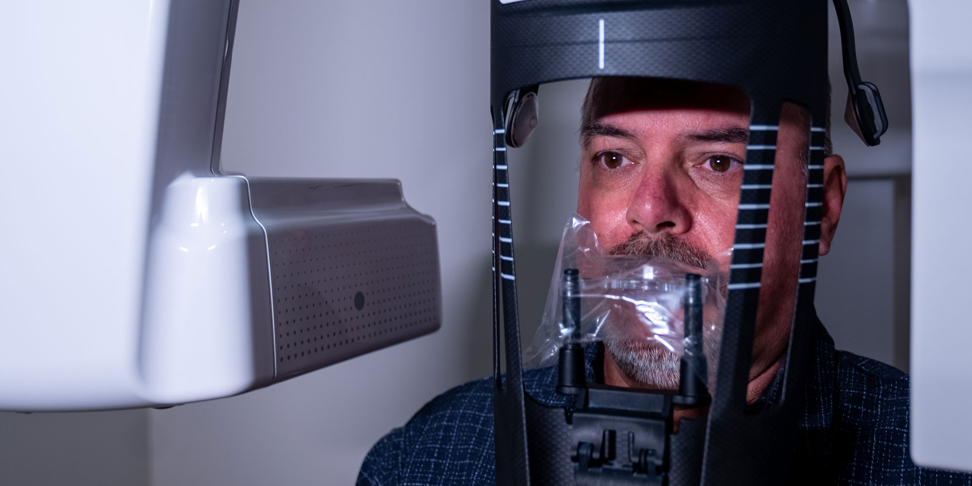 Patient taking a dental x-ray of their teeth