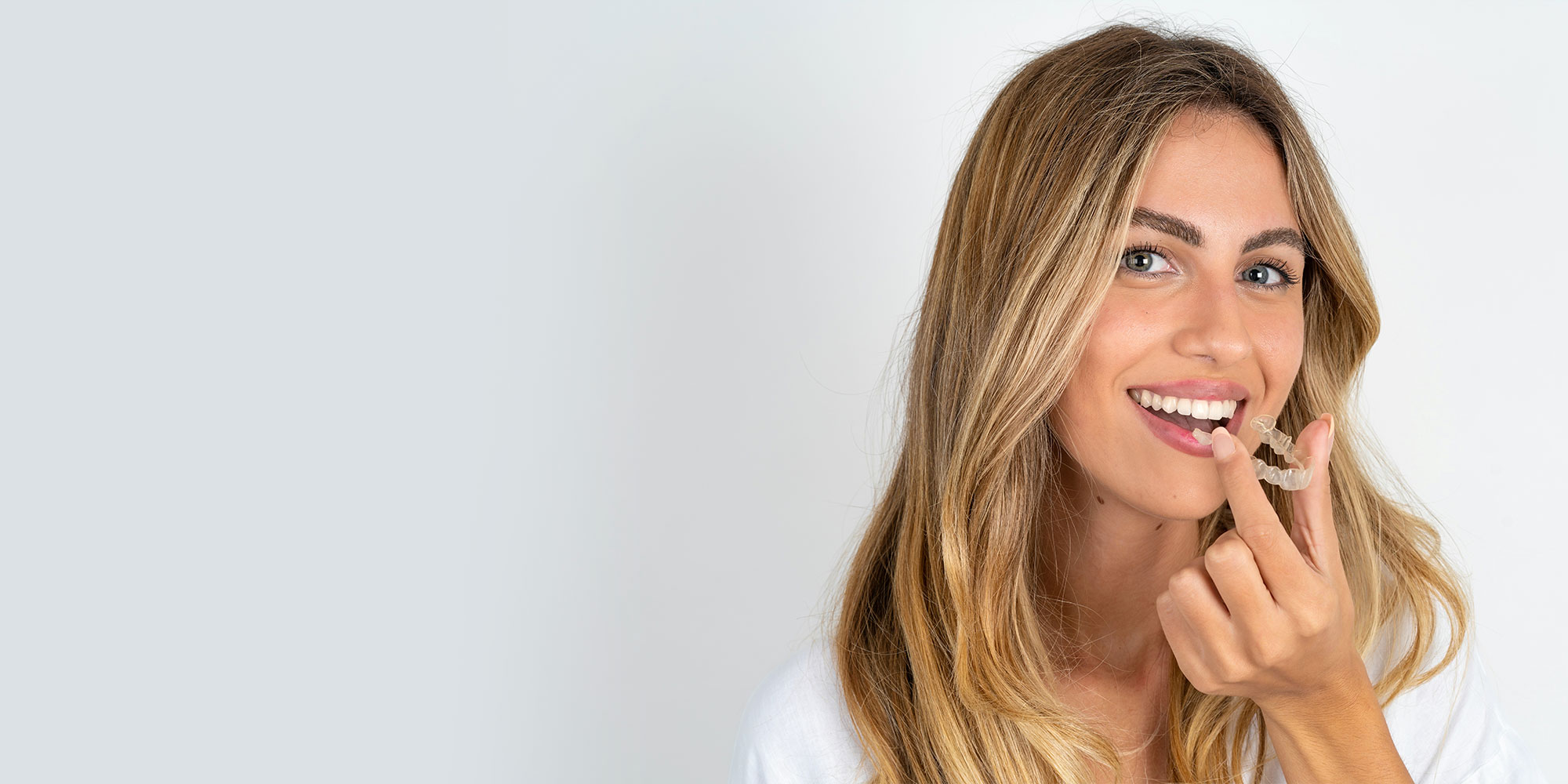 Woman holding invisalign