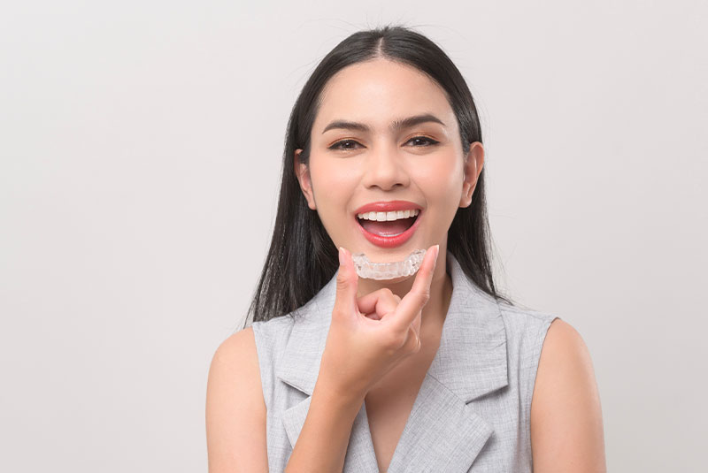 Woman holding invisalign